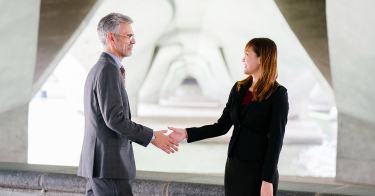 professional man and woman shaking hands